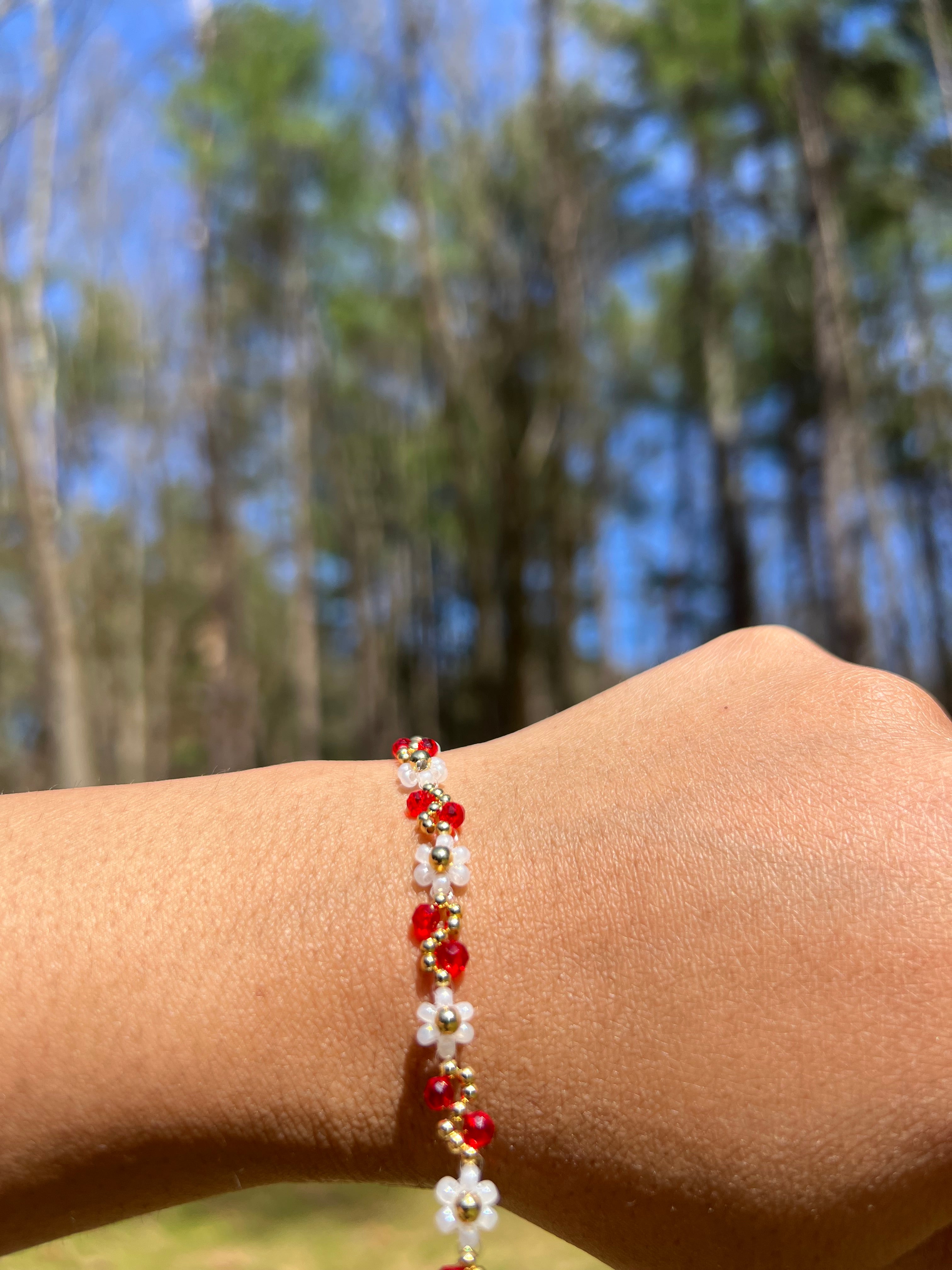 White flowers with Red and gold bracelet