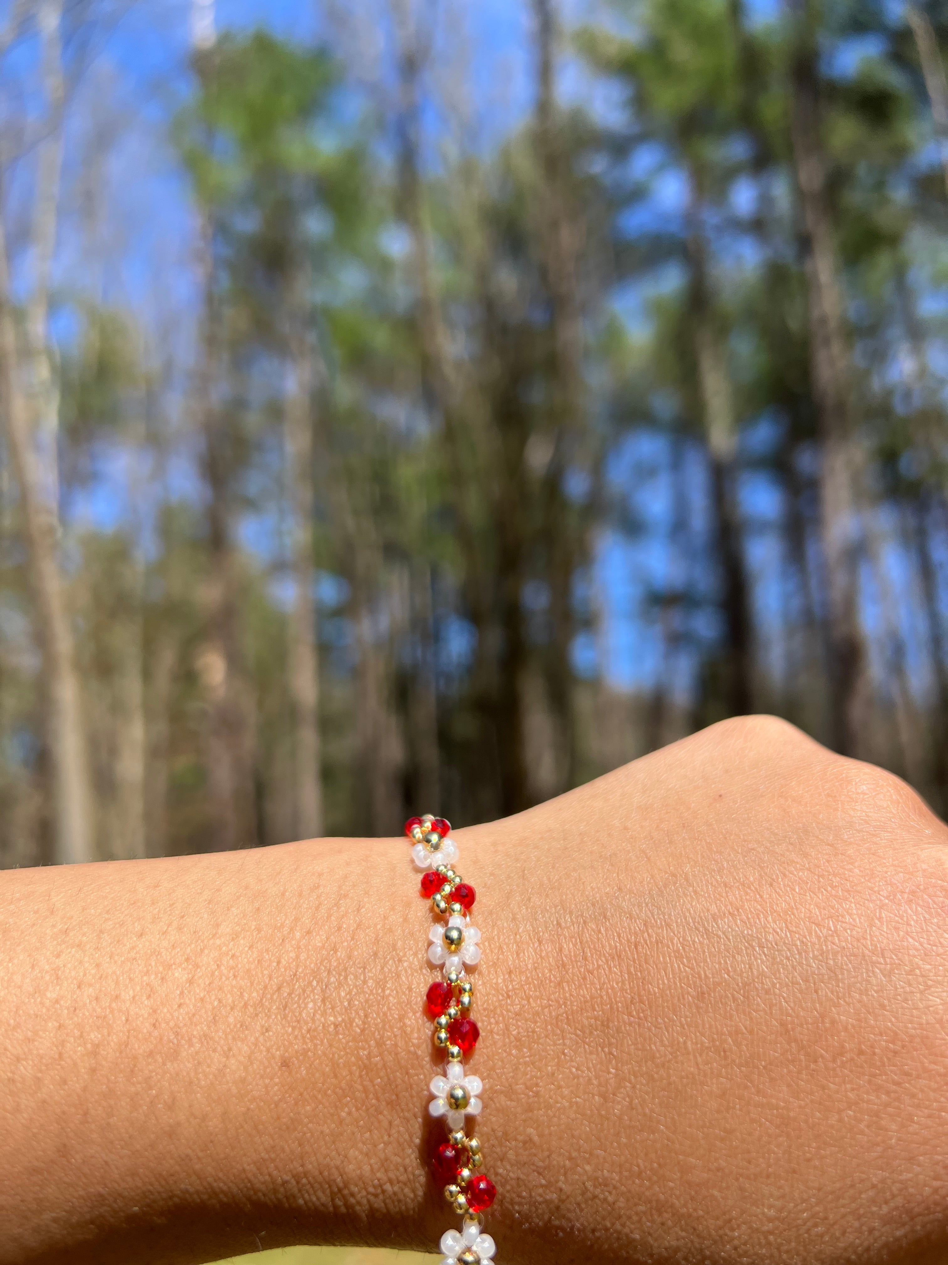 White flowers with Red and gold bracelet