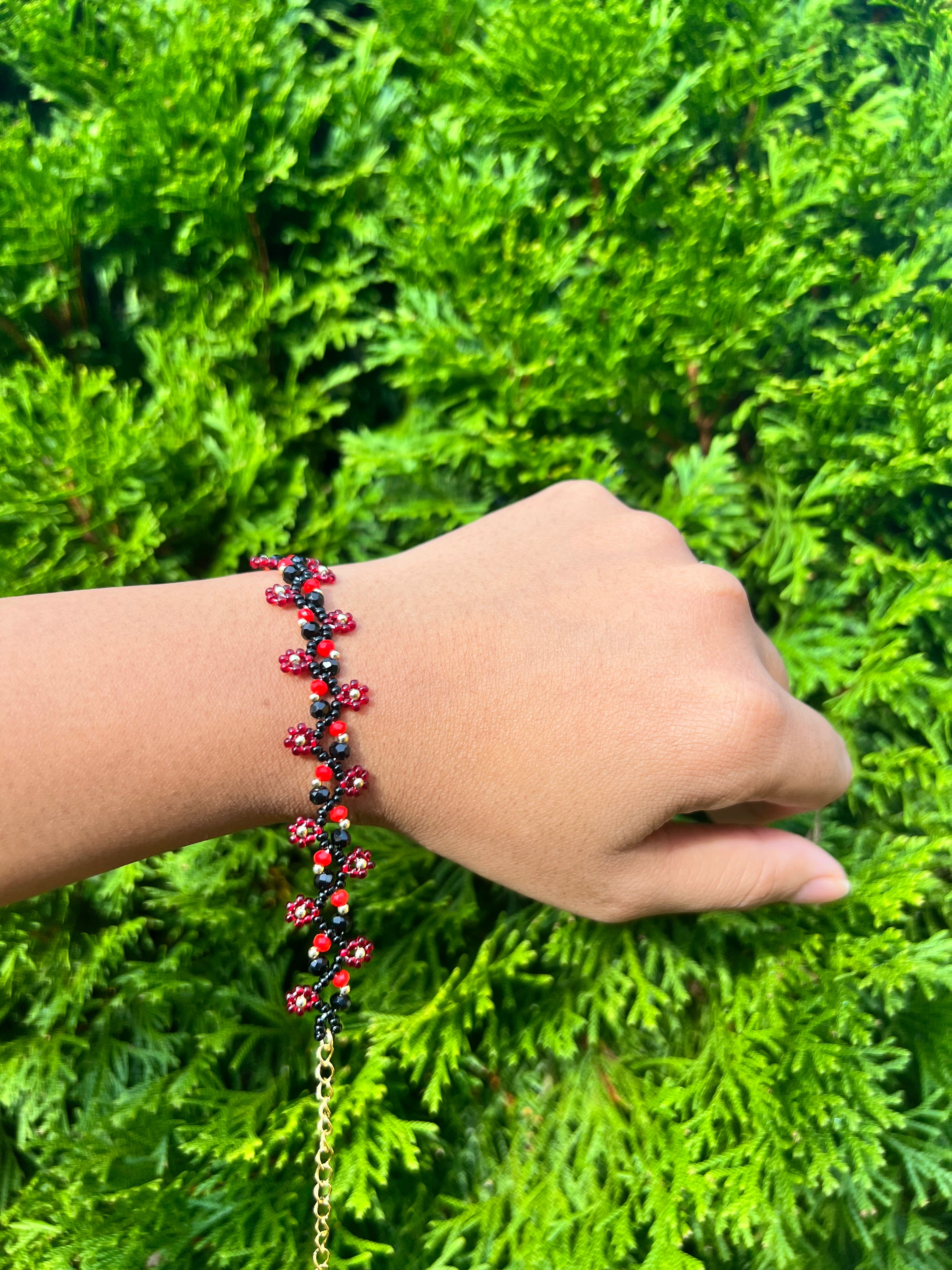 Red and black daisy bracelet with gold accents