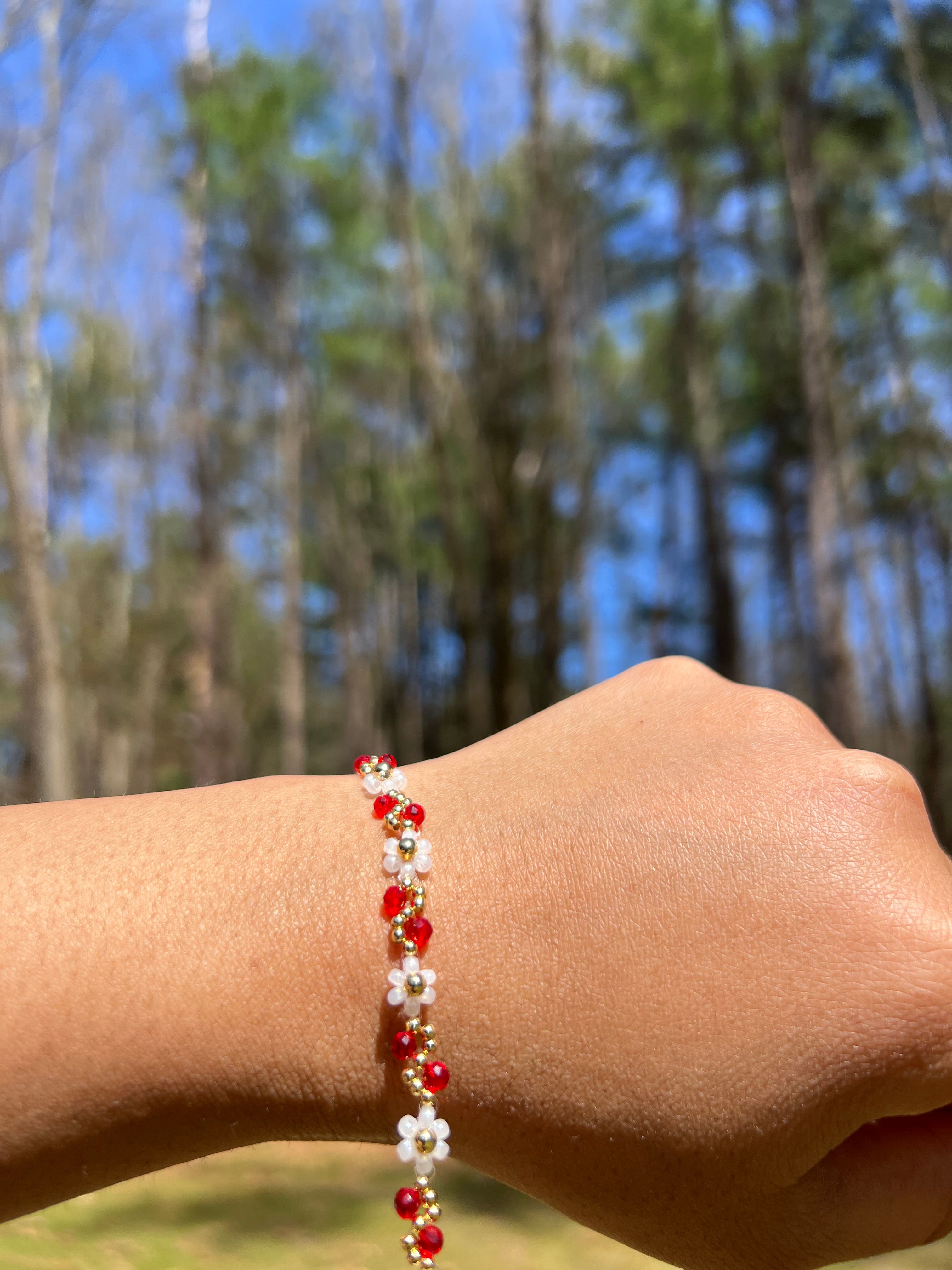 White flowers with Red and gold bracelet