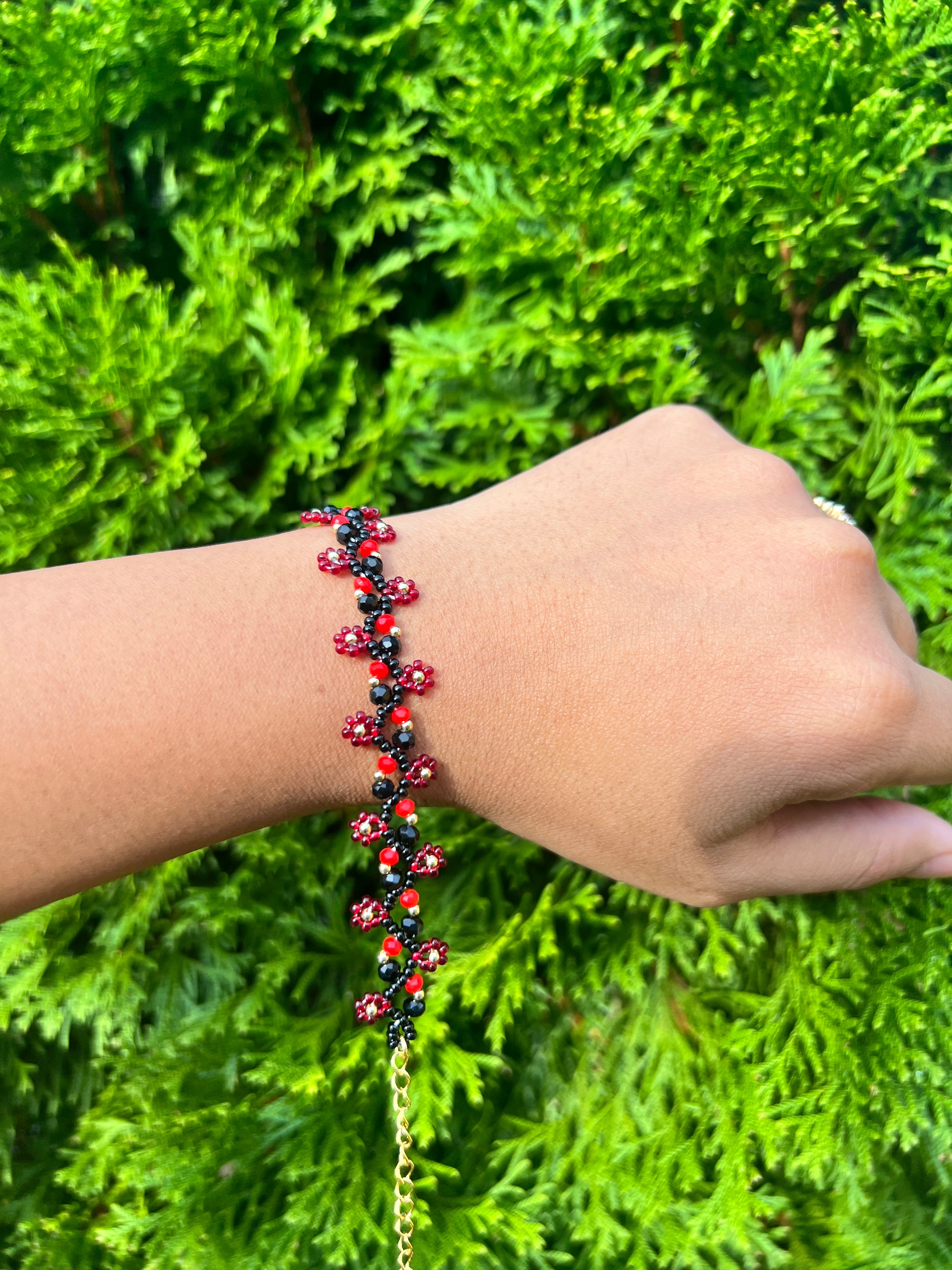 Red and black daisy bracelet with gold accents